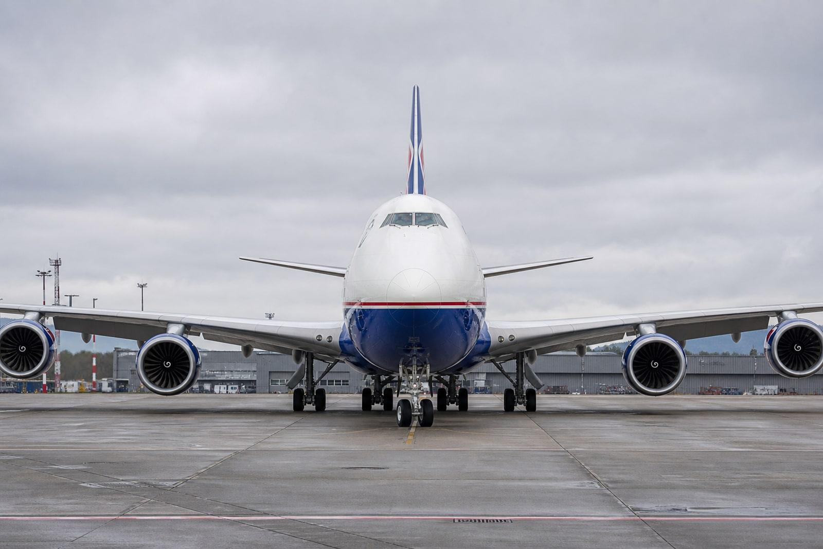 A white Cargolux Boeing 747 freighter with royal-blue underbelly and red cheatline parked on the apron at Luxembourg Airport.