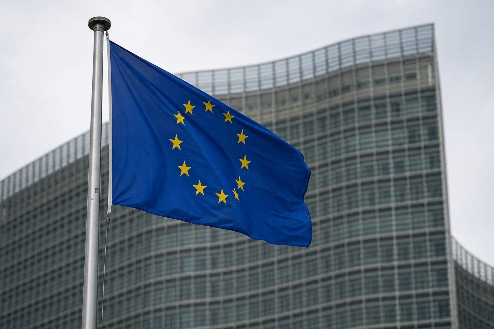 The European Union flag flying on a pole outside the Berlaymont, the European Commission headquarters in Brussels.