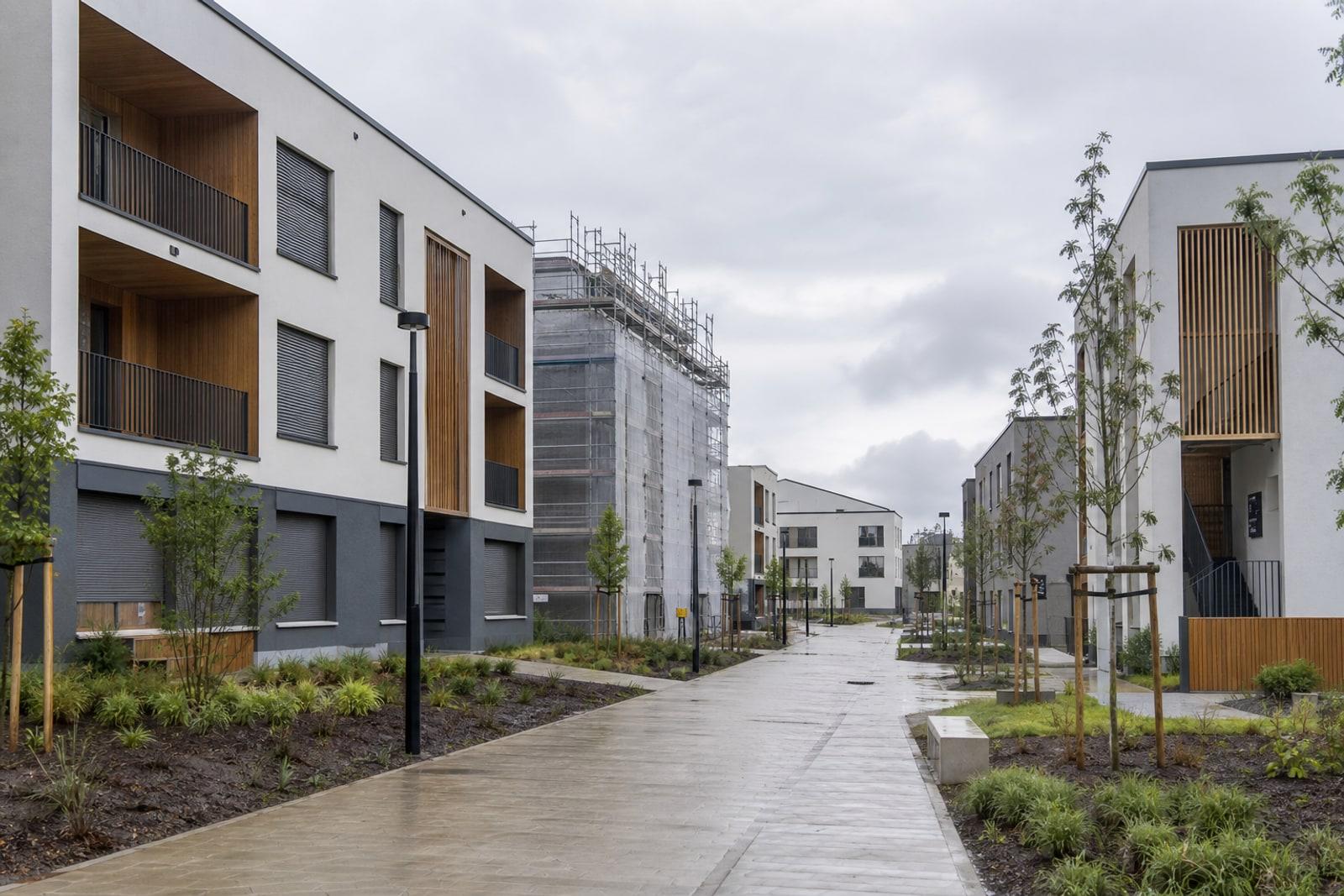 Newly built affordable apartment blocks with timber cladding in the Elmen district in Kehlen, Luxembourg, one building still under scaffolding