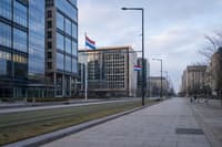 Glass-and-steel office buildings and Luxembourg flags in the Kirchberg financial district.