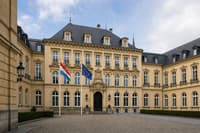 The ornate sandstone Mansfeld Building housing Luxembourg’s Foreign Ministry, with Luxembourg and EU flags outside