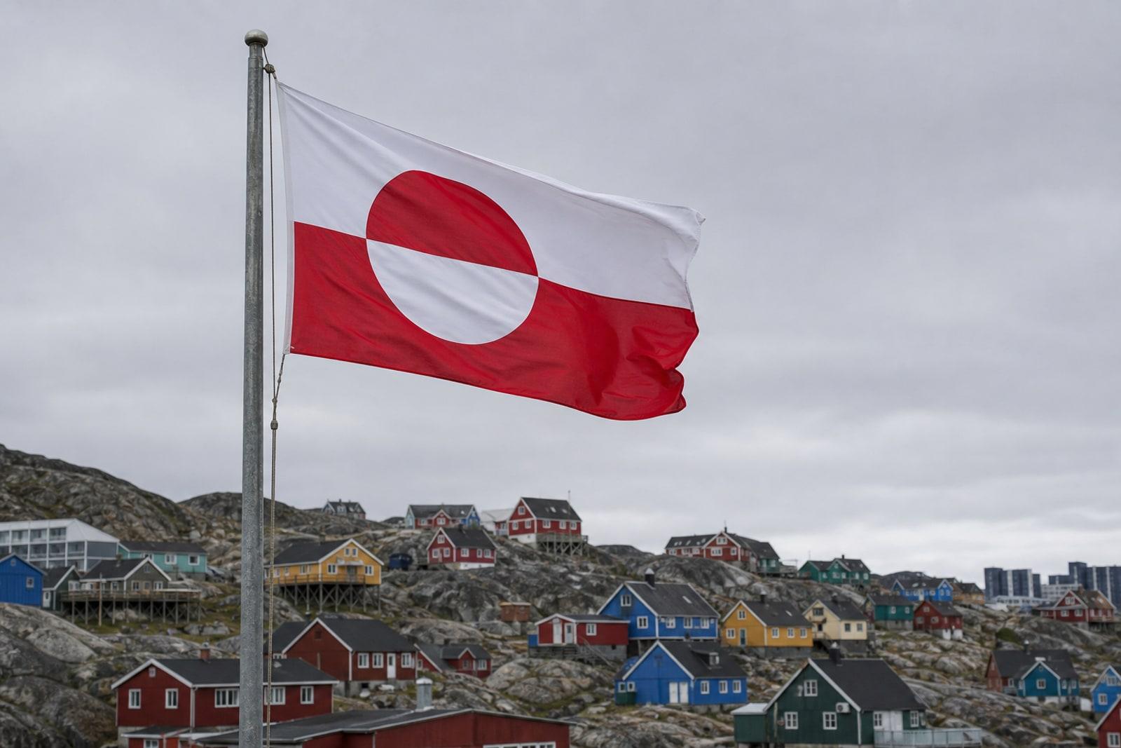 Die grönländische Flagge Erfalasorput weht über der Hauptstadt Nuuk vor arktischer Kulisse.