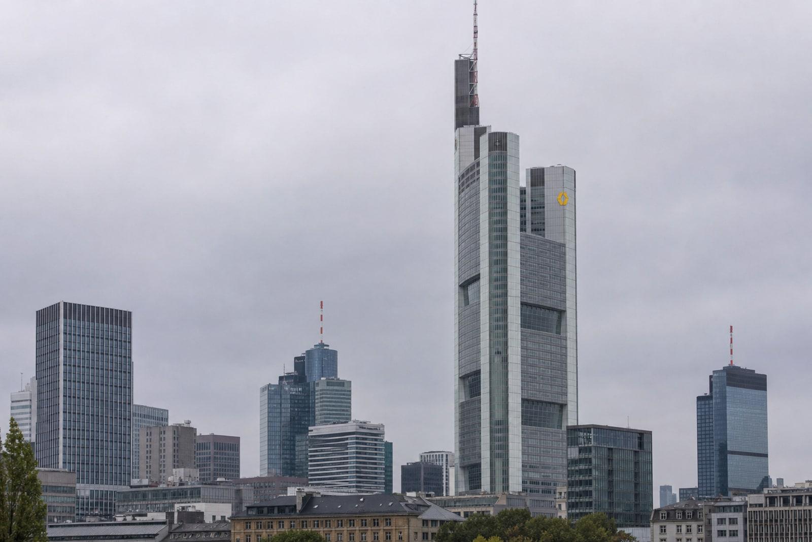 The Commerzbank Tower skyscraper rising over Frankfurt's financial district, bearing Commerzbank's yellow ribbon emblem.